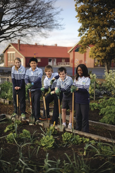 four children in a school vegetable garden