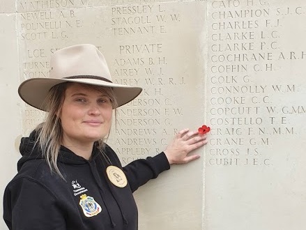 Mel Burnett points at Private Craig's name engraved on the memorial wall at Villers-Bretonneux