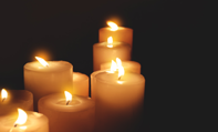 Lit candles lighting up a dark space
