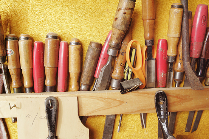 Various hand tools mounted on wall
