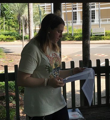 Bridie Latimer reading an essay
