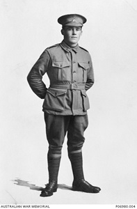 A black and white photo of a man in a military uniform