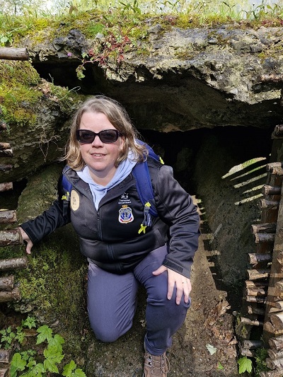A woman climbing out of a trench