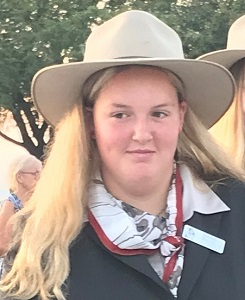 Taleah Smith wearing Frank MacDonald MM Memorial Study Tour uniform, a suit jacket, poppy scarf and Akubra hat