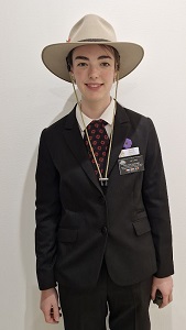 A young woman in a uniform wearing an Akubra hat