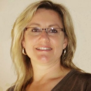 Tanya Brown has blonde hair and is wearing glasses