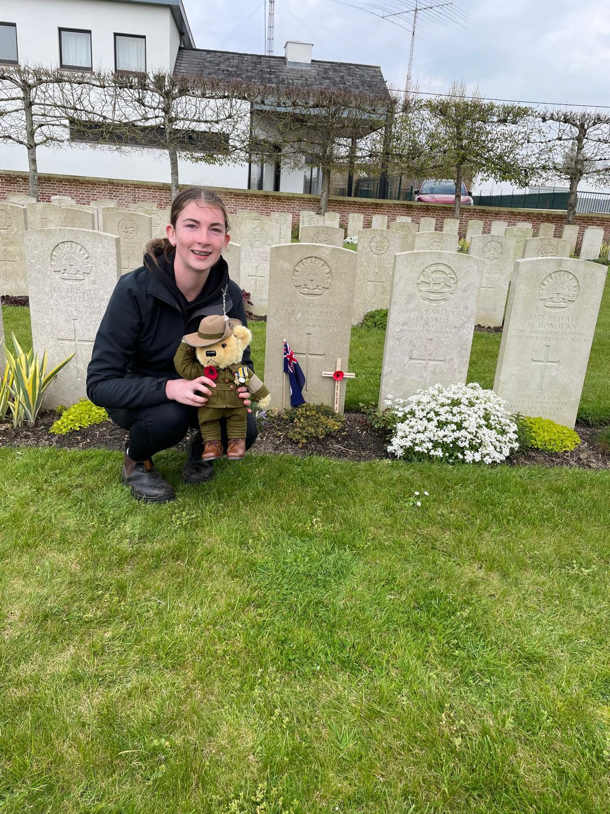 Amy Willey at the gravestone of Vernon Alfred Charlies Batchelor 