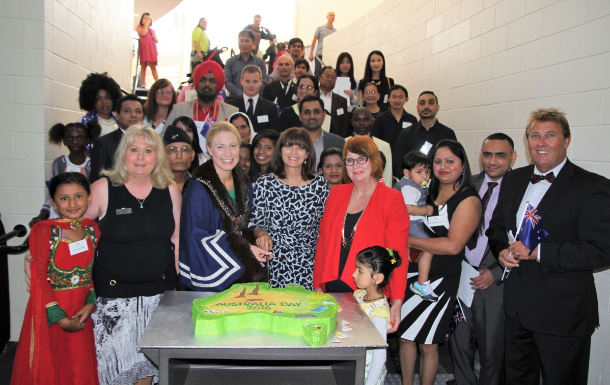 Fiona McIntosh with crowd in front of an Australian continent shaped cake
